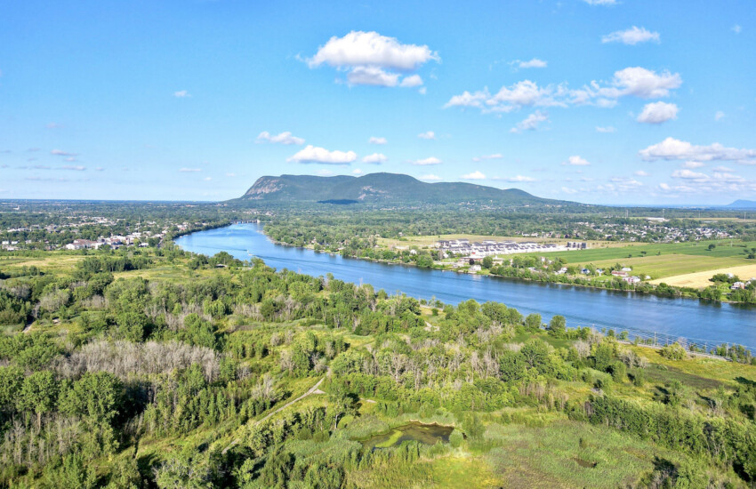 vue sur un paysage du Québec avec rivière au premier plan et mont Saint-Hilaire en arrière-plan